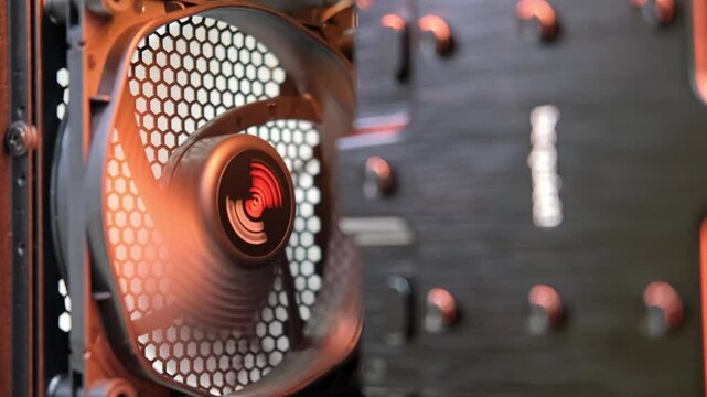 Computer cooling fan with red LED lights spinning inside a modern gaming PC case showcasing intricate design and technology in a dynamic environment