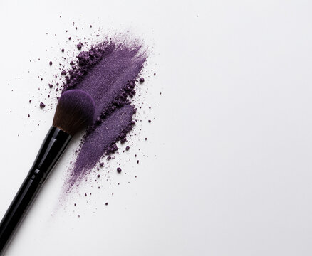 Makeup brush with crushed purple eyeshadow on white background. Creative beauty composition with copy space, perfect for cosmetics branding and makeup tutorials. - Powered by Adobe