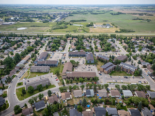 Residential area with houses and a few cars parked on the street