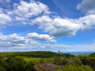 Obraz premium Hiking trails in Dover, England, with the historic Dover Castle visible in the distance. Concept of outdoor adventure, walking routes along the English coastline, and exploring cultural landmarks