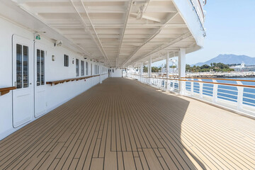 Cruise ship windows overlooking calm waters and distant mountains