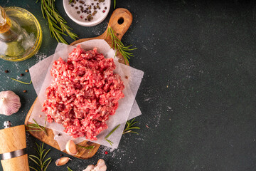 Ground beef, minced meat ready for cooking dinner. Food cooking background with raw minced meat,...