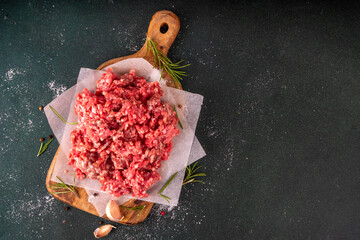 Ground beef, minced meat ready for cooking dinner. Food cooking background with raw minced meat,...