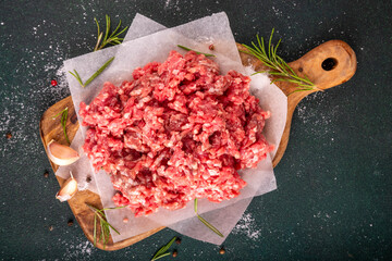 Ground beef, minced meat ready for cooking dinner. Food cooking background with raw minced meat,...