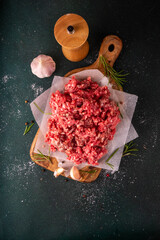 Ground beef, minced meat ready for cooking dinner. Food cooking background with raw minced meat,...