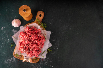 Ground beef, minced meat ready for cooking dinner. Food cooking background with raw minced meat,...