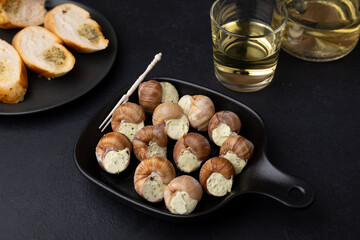 Escargot bourguignon with butter and garlic. Traditional French dish made from snails, served with...