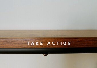 Wood shelf with text written Take Action - means to do something now or to act in order to get a particular result, no more procrastination