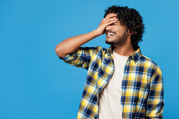 Young happy Indian man he wear yellow checkered shirt casual clothes put hand on face facepalm epic...