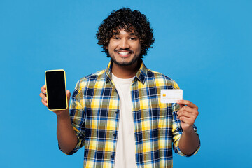 Young Indian man he wear yellow checkered shirt casual clothes using blank screen mobile cell phone...