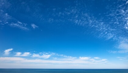 Obraz premium expansive blue sky with delicate wispy white clouds stretching across the horizon in a serene and calm atmosphere