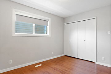 White room with a window and a closet