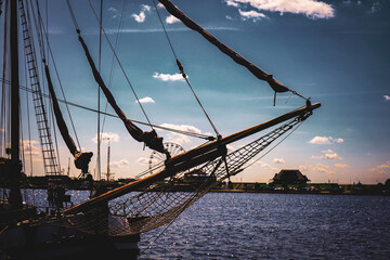 Sailboat with a distinctive bow against an idyllic sky in the large harbor basin at Bontekai in...