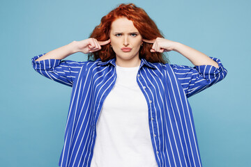 Young sad ginger woman she wear shirt t-shirt casual clothes cover ears with hands fingers do not...