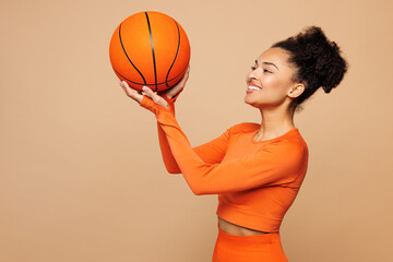 Young fitness trainer instructor sporty woman sportsman wear orange clothes spend time in home gym...