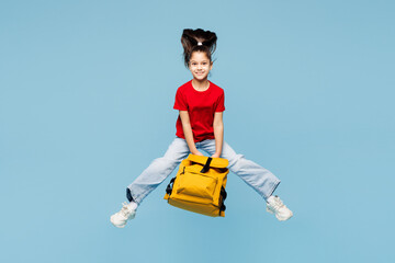 Young smart overjoyed happy school girl 8-9 years old pony tail wears red t-shirt hold backpack...