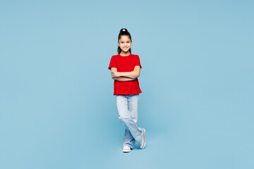 Full body happy little kid girl 8-9 years old wears red t-shirt have fun hold hands crossed folded...