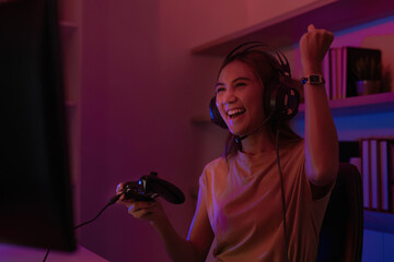Excited Gamer Celebrating Win. Young woman enjoying gaming at home.