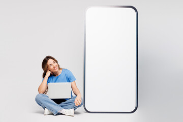 Full body young IT woman she wear blue t-shirt casual clothes big huge blank screen mobile cell...