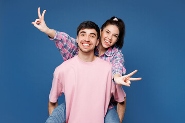 Young couple two friends family man woman they wear pink casual clothes together giving piggyback...