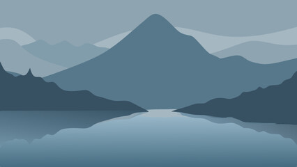 Misty blue mountain peaks and forest silhouettes at sunrise