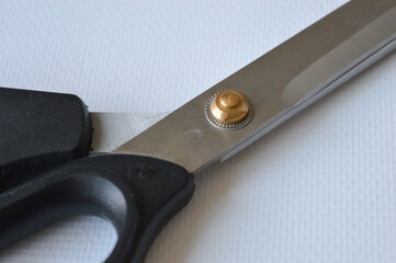 hand holding large metal scissors with black handle  ideal for themes like sewing, crafting, cutting, DIY projects, tailoring, textile work, or home office supplies