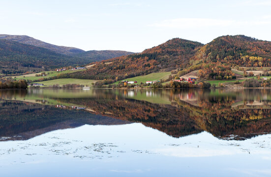 Peaceful autumn Norwegian landscape featuring a calm lake