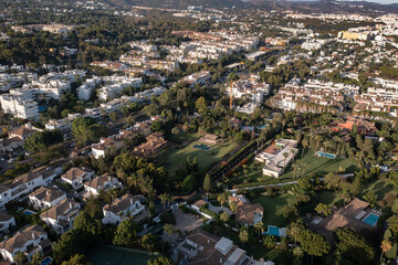 Marbella's Golden Mile: Coastal Luxury and Mediterranean Beauty

An aerial view of Marbella's coastline, showcasing a long sandy beach, azure sea, and exclusive villas nestled among lush greenery
