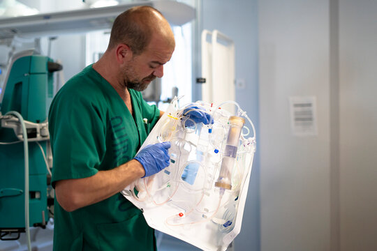 Doctor preparing extracorporeal membrane oxygenation in hospital operating room