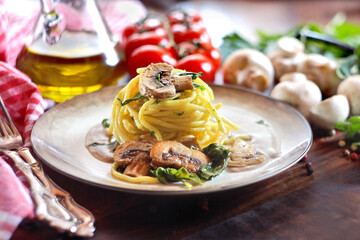 Spaghetti with mushroom and spinach on a wooden background