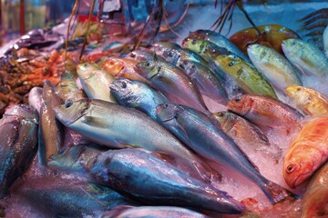 Fresh fish on ice at market stall: Variety of seafood display