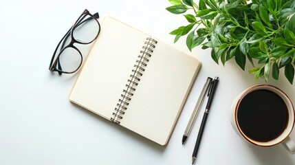 Blank Notebook with Pens, Glasses, and Coffee on a White Desk