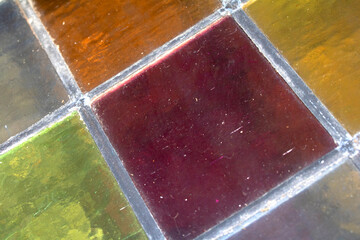 Close up abstract square stained glass window sections multicoloured background