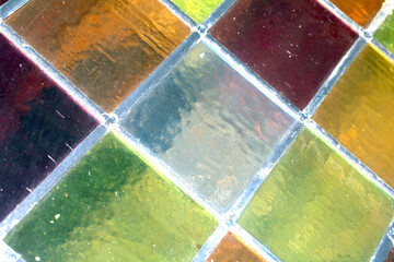 Close up abstract square stained glass window sections multicoloured background