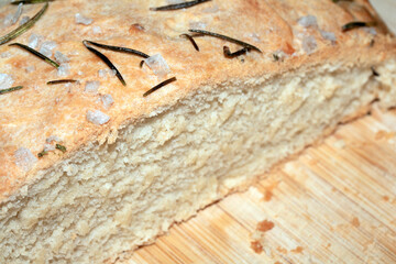 Close up of home made focaccia bread ready baked in the oven with rosemary