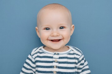 A baby with bright blue eyes is shown in a close-up, looking directly at the camera