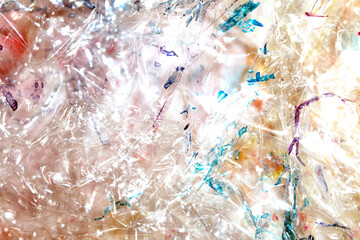 Absract background of shiny plastic and bubbles dreating bright sci-fi style texture background