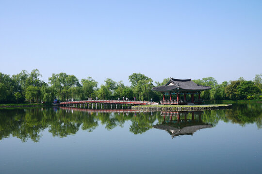 a traditional Korean pavilion in the lake
