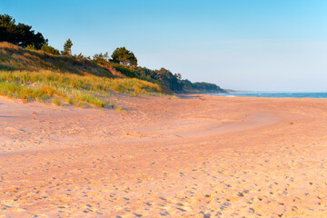 Sandy beach at sunrise on the Polish coast, Dąbki, Poland.