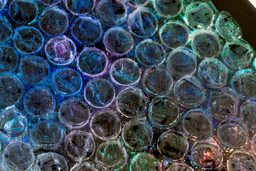 Absract background of shiny plastic and bubbles dreating bright sci-fi style texture background
