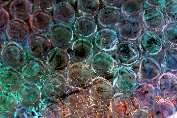 Absract background of shiny plastic and bubbles dreating bright sci-fi style texture background