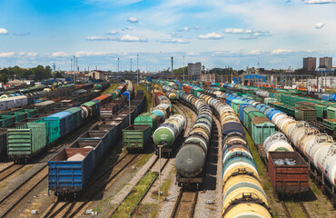 Freight Train Yard with Colorful Cargo Cars Under Clear Sky