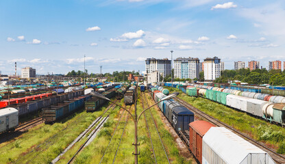 Freight Train Yard with Colorful Cargo Cars Under Clear Sky