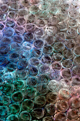 Absract background of shiny plastic and bubbles dreating bright sci-fi style texture background