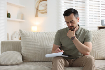 Professional psychologist with clipboard in his office. Space for text