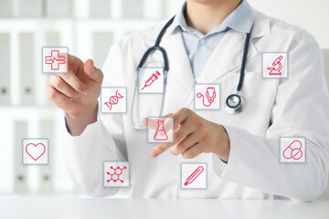 Doctor using virtual screen with healthcare icons in office, closeup