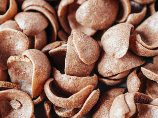 Chocolate cereals corn flakes top view 
Cornflakes pile for breakfast, heap of brown choco cereals, close-up of crispy rice flakes