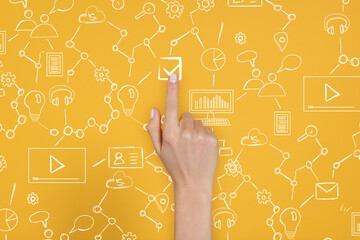 Woman putting tick into checkbox on virtual screen with scheme against orange background, closeup