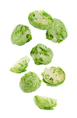 Fresh ripe cabbages falling on white background