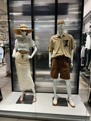Stylish mannequin summer display in modern retail clothing store setting
